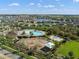 Aerial view of the community pool and playground area in a neighborhood with waterfront homes and lush landscaping at 11717 Navajo Sandstone St, Riverview, FL 33579