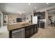 Kitchen island with bar stool seating and a large stainless steel refrigerator at 11717 Navajo Sandstone St, Riverview, FL 33579