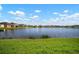 Beautiful lake view surrounded by a lush green lawn with other homes visible in the distance at 11717 Navajo Sandstone St, Riverview, FL 33579