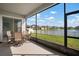 Enclosed patio with outdoor seating and a view of the lake at 11717 Navajo Sandstone St, Riverview, FL 33579