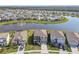 Aerial view shows home in a community near a pond with fountain and well-maintained landscaping at 12326 Dora Trl, Parrish, FL 34219