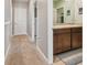 Hallway view of a Jack and Jill bathroom with double sinks and a large mirror at 12326 Dora Trl, Parrish, FL 34219