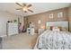 Bright bedroom with a stylish decorative dresser, vanity, and a comfortable patterned bed at 12326 Dora Trl, Parrish, FL 34219