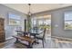 Elegant dining room with a wooden table, bench seating, and a view of the backyard through sliding glass doors at 12326 Dora Trl, Parrish, FL 34219