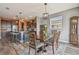 Cozy dining room with a dark wood table, vintage accents, and an adjacent kitchen area for easy entertaining at 12326 Dora Trl, Parrish, FL 34219