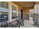 Cozy covered front porch with black rocking chairs at 12326 Dora Trl, Parrish, FL 34219