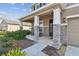 Relaxing front porch with stone supports and two rocking chairs at 12326 Dora Trl, Parrish, FL 34219