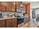 Kitchen featuring a stove, stainless steel microwave and cabinets plus stone countertop at 12326 Dora Trl, Parrish, FL 34219