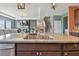 Kitchen island featuring double sinks, granite countertop, wood cabinets, stainless steel appliances at 12326 Dora Trl, Parrish, FL 34219