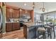 Kitchen with island with granite countertop, stainless steel appliances and wooden cabinets at 12326 Dora Trl, Parrish, FL 34219