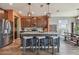 Kitchen with center island with stone countertop and seating plus stainless steel appliances at 12326 Dora Trl, Parrish, FL 34219