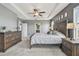 This is a spacious main bedroom featuring a trey ceiling, a ceiling fan, and generous natural light at 12326 Dora Trl, Parrish, FL 34219