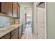 Kitchen featuring wood cabinets and a view into the dining area at 12326 Dora Trl, Parrish, FL 34219