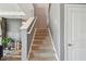 Carpeted staircase with white railing leading to the upper level of the home near the entryway at 12326 Dora Trl, Parrish, FL 34219