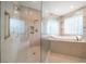 Luxurious bathroom with a glass-enclosed shower and a soaking tub at 1370 Pinellas Rd, Belleair, FL 33756