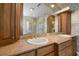 Elegant bathroom featuring a double sink vanity with granite countertop and glass-enclosed shower at 1370 Pinellas Rd, Belleair, FL 33756