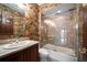 Bathroom featuring a tub with glass door and a vanity with wallpaper at 1370 Pinellas Rd, Belleair, FL 33756