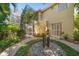 Charming home exterior featuring lush landscaping and a unique stone water feature at 1370 Pinellas Rd, Belleair, FL 33756