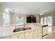 Kitchen countertop and sink area with view of a living area and outdoor pool at 1370 Pinellas Rd, Belleair, FL 33756