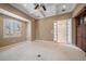 Cozy living room features a large window, neutral color palette, and ceiling can lighting at 1370 Pinellas Rd, Belleair, FL 33756