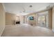 Spacious living room with a fireplace and access to a balcony at 1370 Pinellas Rd, Belleair, FL 33756