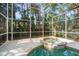 Relaxing spa with screened-in enclosure providing backyard privacy and shade for homeowners at 1370 Pinellas Rd, Belleair, FL 33756