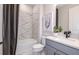 This bathroom features a shower and tub combination with stylish tile and a modern vanity at 13727 Evergreen Valley Dr, Riverview, FL 33578