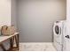 This laundry room features a washer and dryer, counter space, and neutral finishes at 13727 Evergreen Valley Dr, Riverview, FL 33578