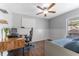 Bedroom featuring bed, desk and chair, and wood-look laminate flooring at 13815 Capitol Dr, Tampa, FL 33613