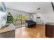 Cozy living room with hardwood floors, a comfortable sofa, and bright natural light from the window at 13815 Capitol Dr, Tampa, FL 33613