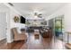 Open living room featuring wood floors, a large leather sofa, and sliding glass doors to the outdoors at 13815 Capitol Dr, Tampa, FL 33613