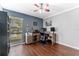 Home office with desk, dark blue walls, and laminate flooring at 13815 Capitol Dr, Tampa, FL 33613