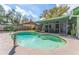 Inviting backyard pool with screened enclosure and lush landscaping offering a private outdoor oasis at 13815 Capitol Dr, Tampa, FL 33613