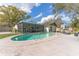 Backyard pool view showcases the home's serene outdoor space and covered patio perfect for relaxation at 13815 Capitol Dr, Tampa, FL 33613