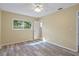 Bedroom with wood-look floors, ceiling fan, and natural light at 14350 Hill Country Rd, Brooksville, FL 34614