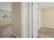 Hallway featuring a glimpse of a bedroom, door, and closet space at 14350 Hill Country Rd, Brooksville, FL 34614