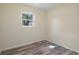 Bedroom featuring a window letting in natural light and wood-look floors at 14350 Hill Country Rd, Brooksville, FL 34614