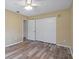 Bedroom featuring light wood flooring, cream walls, and a closet at 14350 Hill Country Rd, Brooksville, FL 34614