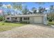 Attractive single-story home with a gravel driveway and attached garage at 14350 Hill Country Rd, Brooksville, FL 34614