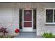 Charming front door with brick accents, sidelights, and a decorative window at 14350 Hill Country Rd, Brooksville, FL 34614