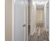 Inviting hallway featuring wood-look floors and neutral wall color throughout the home at 14350 Hill Country Rd, Brooksville, FL 34614