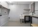 Laundry area featuring utility sink and table on finished walls and floor at 14350 Hill Country Rd, Brooksville, FL 34614