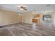 Open-concept living area with wood-look flooring adjacent to the kitchen at 14350 Hill Country Rd, Brooksville, FL 34614