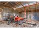 Interior view of outbuilding, showing lawn tractor and trailer for property maintenance at 14350 Hill Country Rd, Brooksville, FL 34614