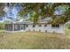 Exterior view of the house with screened in porch and well maintained yard at 14350 Hill Country Rd, Brooksville, FL 34614