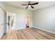 Bright bedroom features light wood flooring and a ceiling fan at 14700 Seminole Trl, Seminole, FL 33776