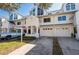 Townhome exteriors showing crisp white facade, attached garages, and well-manicured lawns on a sunny day at 14700 Seminole Trl, Seminole, FL 33776