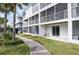 View of building with walkways, balconies, and tropical landscaping at 14700 Seminole Trl, Seminole, FL 33776