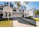 Townhome exteriors showing crisp white facade, attached garages, and well-manicured lawns on a sunny day at 14700 Seminole Trl, Seminole, FL 33776