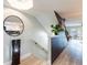 Hallway with wood-look floors, white trim, and a mirror accent wall, creating a bright and open transition space at 14700 Seminole Trl, Seminole, FL 33776